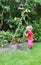 Cute little girl watering plants