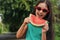 Cute little girl with watermelon outdoors on sunny day