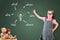 Cute little girl wearing business dress and analyzing problem and find solution, on green chalk board.