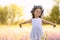 Cute little girl wearing flower wreath outdoors. Child spending time in nature