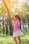 Cute little girl wearing a pink shirt blowing bubbles in the park,vintage style