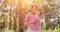 Cute little girl wearing a pink shirt blowing bubbles in the park,vintage style