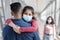 Cute Little Girl Wearing Protective Medical Mask Embracing Father At Airport