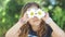 Cute little girl with wet hair, playing with   Shasta daisy flowers, making faces, having fun; positive emotions, slow motion