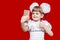 Cute little girl in white bows hold telephone and take picture on red background