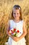 Cute little girl with wild flowers red poppy bouquet