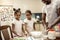 Cute little girls having flour on their faces and bodies while cooking