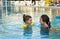 Cute little girls swimming in outdoor pool