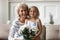 Cute little granddaughter greeting granny with anniversary