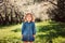 Cute little happy toddler girl portrait walking in spring or summer park