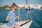 Cute little healthy child in sunglasses sitting aboard luxury recreational boat