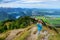 Cute little hiker enjoying picturesque views from the Tegelberg mountain, a part of Ammergau Alps, located nead Fussen town, Germa