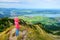 Cute little hiker enjoying picturesque views from the Tegelberg mountain, a part of Ammergau Alps, located nead Fussen town, Germa