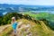 Cute little hiker enjoying picturesque views from the Tegelberg mountain, a part of Ammergau Alps, located nead Fussen town, Germa