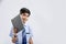 Cute little Indian/Asian school boy showing note book over white background