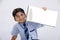 Cute little Indian/Asian school boy showing note book over white background