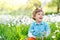 Cute little kid boy with Easter bunny ears celebrating traditional feast. Happy child smiling on warm sunny day. Family