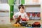 Cute little kid boy playing with lots of toy cars indoor. Happy preschooler having fun at home or nursery. Big collection of