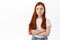 Cute little kid girl, redhead child with freckles look away and sulking, being angry, cross arms on chest and pouting