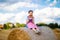 Cute little kid girl in traditional Bavarian costume in wheat field