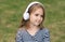 Cute little kid listen to audio language course in headphones outdoors, english