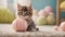 Cute little kitten playing with colorful pastel wool yarn balls. Pets, animal love concept.