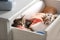 Cute little kittens in open drawer with towels