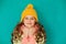 Cute little lady wearing yellow woolen cap and Ñ†Ñ„ÐºÑŒ scarf