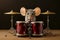 Cute little mouse with drumsticks and drum kit on dark background