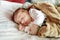 Cute little newborn baby boy sleeping on a blanket. Portrait of tiny new baby at home. New bundle of joy