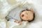 Cute little newborn baby boy sleeping on a blanket. Portrait of tiny new baby at home. New bundle of joy