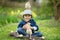 Cute little preschool child, boy, playing with easter eggs and c