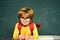 Cute little preschool kid boy in a classroom. Science education concept. Classroom. Little student boy happy with an