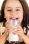 Cute little preschooler girl drinking a glass of