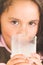 Cute little preschooler girl drinking a glass of