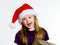 Cute little preschooler girl in red santa hat with gift box