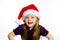 Cute little preschooler girl in red santa hat with gift box