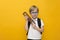 Cute little school boy in glasses holding abacus on yellow background. Mental arithmetic