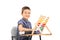 Cute little schoolboy sitting at a school desk