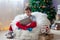 Cute little sick boy, sitting on bean bag, playing on tablet