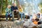 Cute little sisters and their father roasting marshmallows on sticks at bonfire. Children having fun at camp fire. Camping with