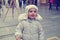 Cute little smiling girl on the street in winter; retro Instagram style