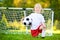 Cute little soccer player having fun playing a soccer game