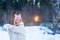 Cute little teenage girl having fun playing with snowballs, ready to throw the snowball