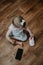Cute little toddler baby girl with cell phone near on the floor. Vertical portrait of kid sitting on floor with mobile