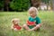 Cute little toddler child, blond boy, eating watermelon in the park