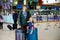 Cute little toddler girl and father at the airport. Happy family traveling by plane, making vacations. Young dad and