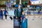 Cute little toddler girl and father at the airport. Happy family traveling by plane, making vacations. Young dad and