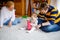 Cute little toddler girl, father and grandmother playing together. baby child, dad and and senior retired woman