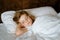 Cute little toddler girl sleeping in bed. Adorable baby child dreaming, healthy sleep of children by day. Deep sleeping